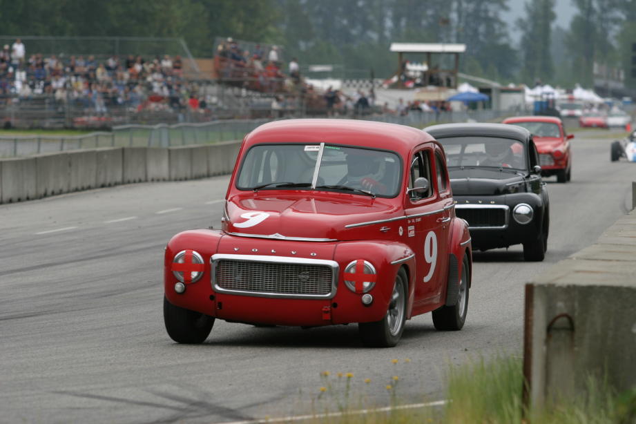 Gil Stuart’s 1958 PV444 leads Peter Valkenburg Black 544 off the front straight.